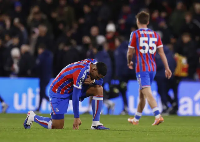 Lacroix kneels on the floor