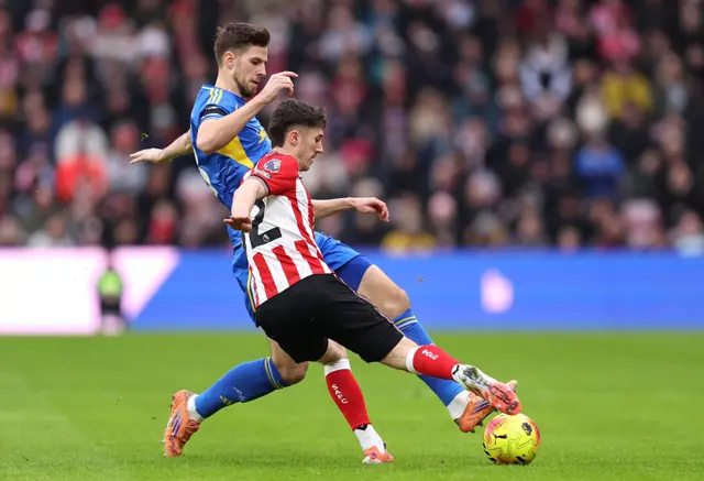 Trai Hume of Sunderland battles for possession with Anton Stach of Leeds