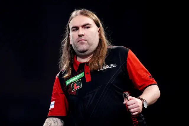England's Ryan Searle celebrates winning the first set during his match against Germany's Martin Schindler on day fifteen of the Paddy Power World Darts Championship at the Alexandra Palace, London