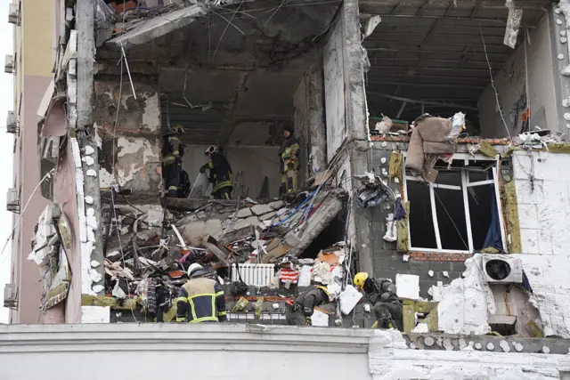 Lực lượng cứu hộ Ukraine tìm kiếm trong đống đổ nát bên trong một tòa nhà dân cư bị hư hại sau vụ tấn công bằng máy bay không người lái và tên lửa của Nga.