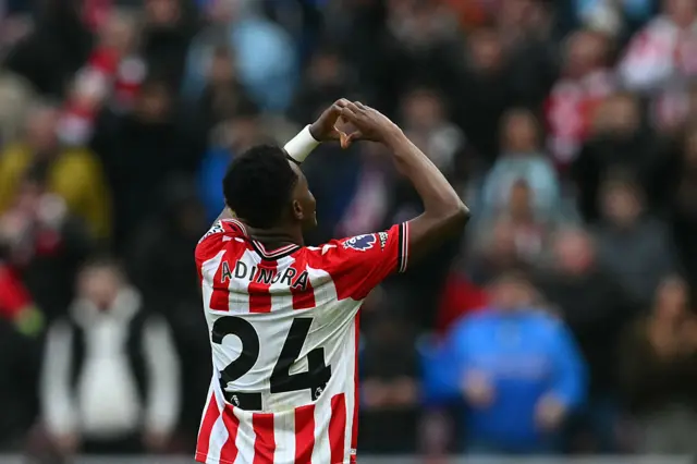 Simon Adingra doing a heart to the fans