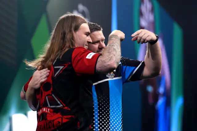 England's Ryan Searle (left) celebrates defeating England's James Hurrell on day sixteen of the Paddy Power World Darts Championship at the Alexandra Palace, London