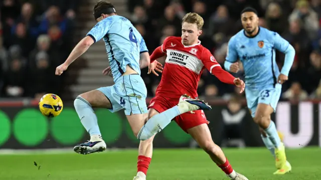 Hull's Charlie Hughes gets to the ball ahead of Middlesbrough's Tommy Conway