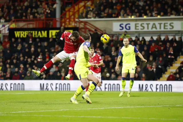 Wrexham's Nathan Broadhead (left) scores