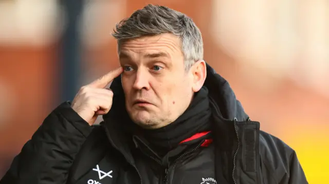 Lincoln boss Michael Skubala points to his eye