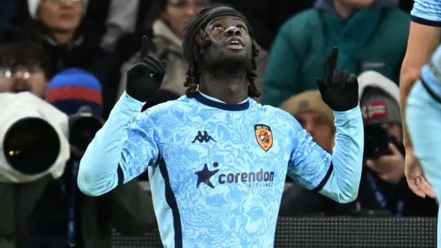 Darko Gyabi points to the sky