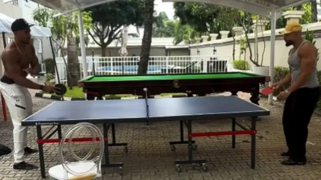 Two men playing table tennis