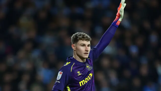 Coventry goalkeeper Carl Rushworth raises his arm