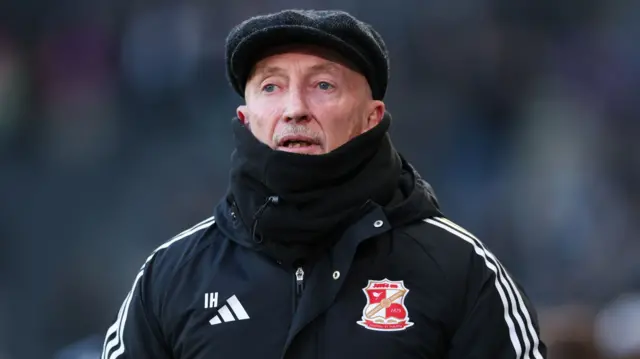 Ian Holloway in a flat cap and snood