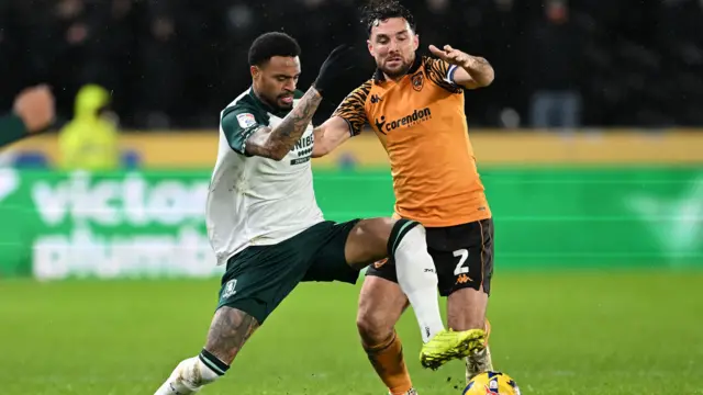 Middlesbrough's Delano Burgzorg (left) tries to knock Hull captain Lewie Coyle off the ball during Boro's 4-1 win at MKM Stadium