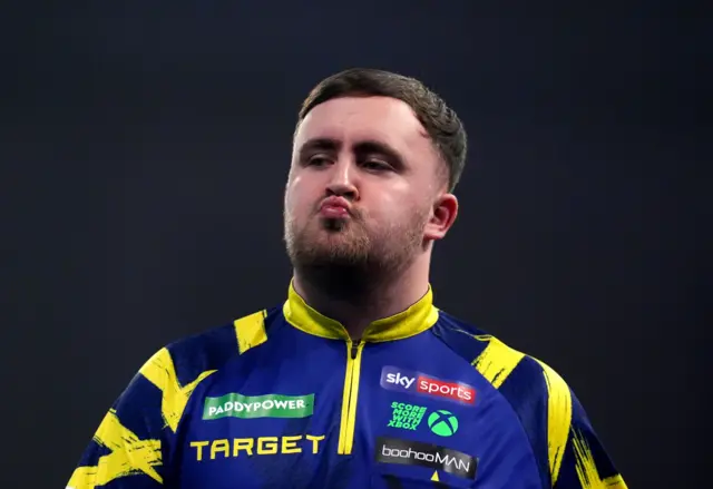 England's Luke Littler reacts during his match England's Rob Cross on day sixteen of the Paddy Power World Darts Championship at the Alexandra Palace, London