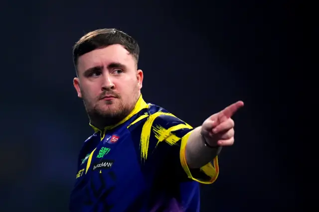 England's Luke Littler reacts during his match England's Rob Cross on day sixteen of the Paddy Power World Darts Championship at the Alexandra Palace, London