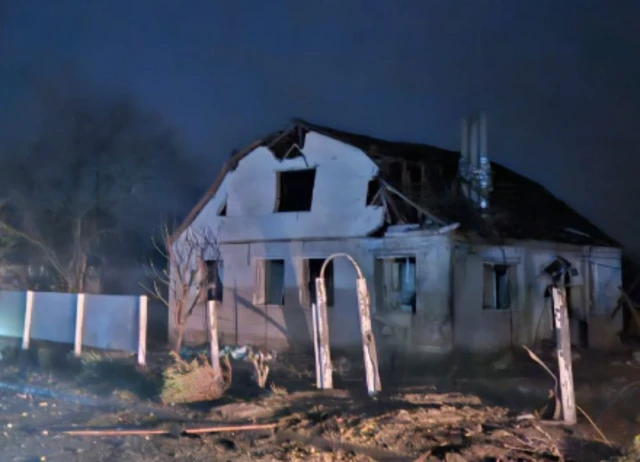 A damaged home in nighttime