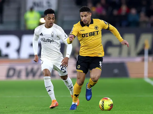 Joao Gomes and Omari Hutchinson chase the ball