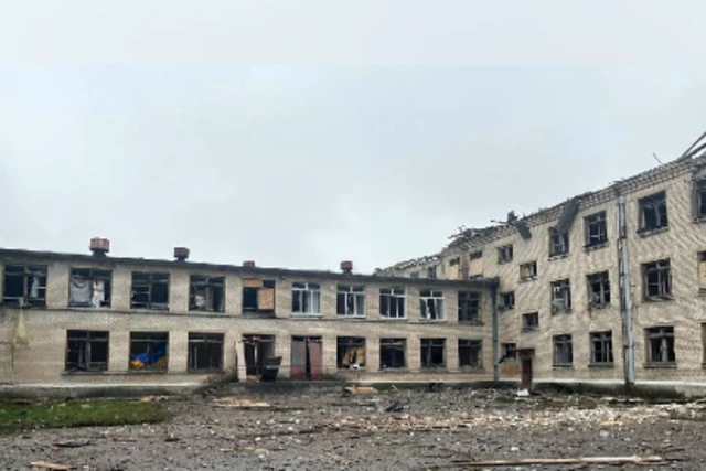 Damaged building with rubble surrounding it