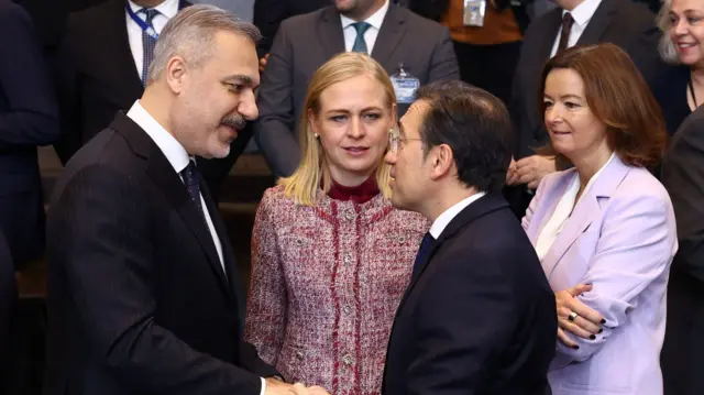 Turkish Foreign Minister Hakan Fidan speaks with Spanish Foreign Minister Jose Manuel Albares Bueno next to Finland's Foreign Minister Elina Valtonen and Slovenia's Foreign Minister Tanja Fajon