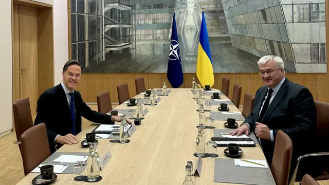Mark Rutte and Andrii Sybiha pictured at opposite ends of a table at Nato HQ
