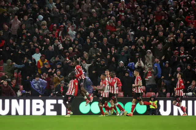 Brian Brobbey of Sunderland celebrates with Romaine Mundle and teammates after scoring his team's third goal during the Premier League match between Sunderland and Bournemouth at Stadium of Light on November 29, 2025 in Sunderland, England.