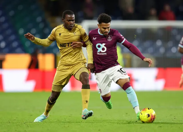 Tyrick Mitchell and Marcus Edwards challenge for the ball