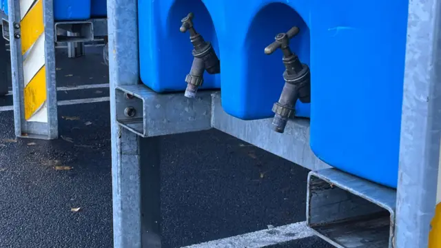 Close up image of two taps on the outside of a large blue container