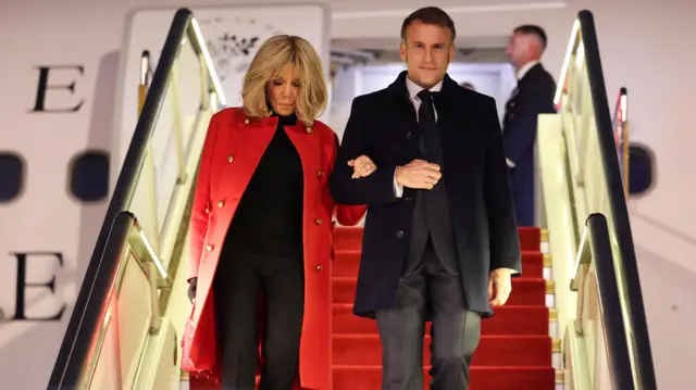 France's President Emmanuel Macron and his wife Brigitte Macron disembark from their plane upon their arrival at the Capital International Airport in Beijing, China, December 3, 2025.
