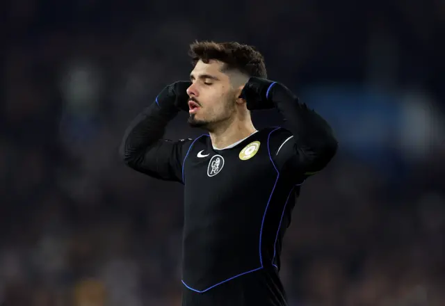 Pedro Neto celebrates with his eyes closed and his fingers in his ears