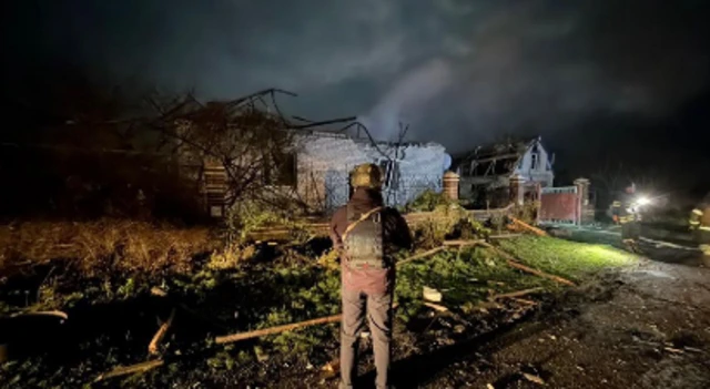 Damaged buildings in a dark sky