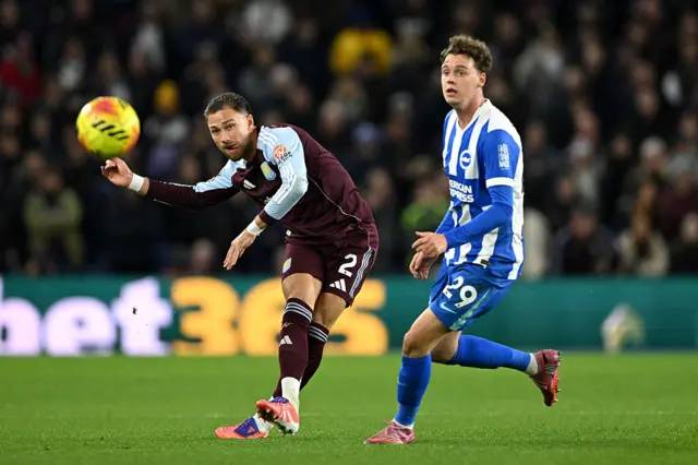 Matty Cash plays the ball under pressure from Maxim de Cuyper