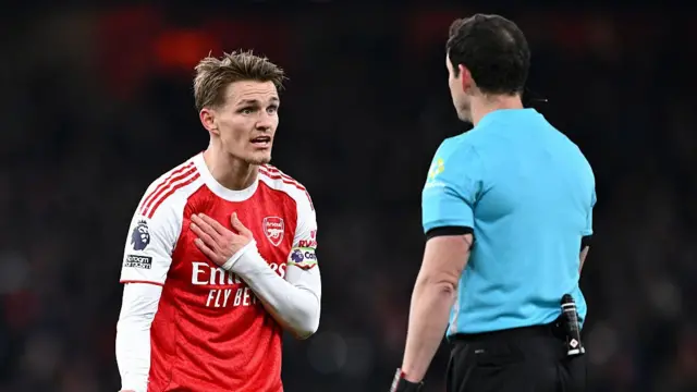 Martin Odegaard of Arsenal speaks with Darren England