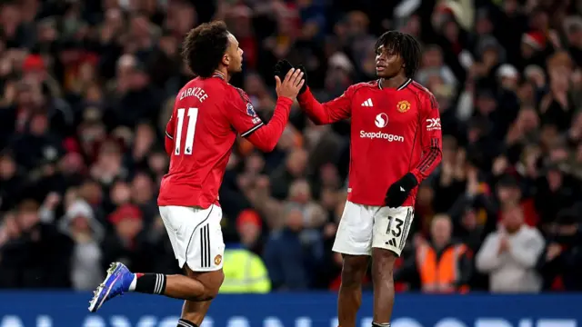 Joshua Zirkzee celebrates scoring with teammate Patrick Dorgu