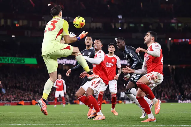 Gabriel of Arsenal watches on as Aston Villa goalkeeper Emiliano Martinez catches the ball