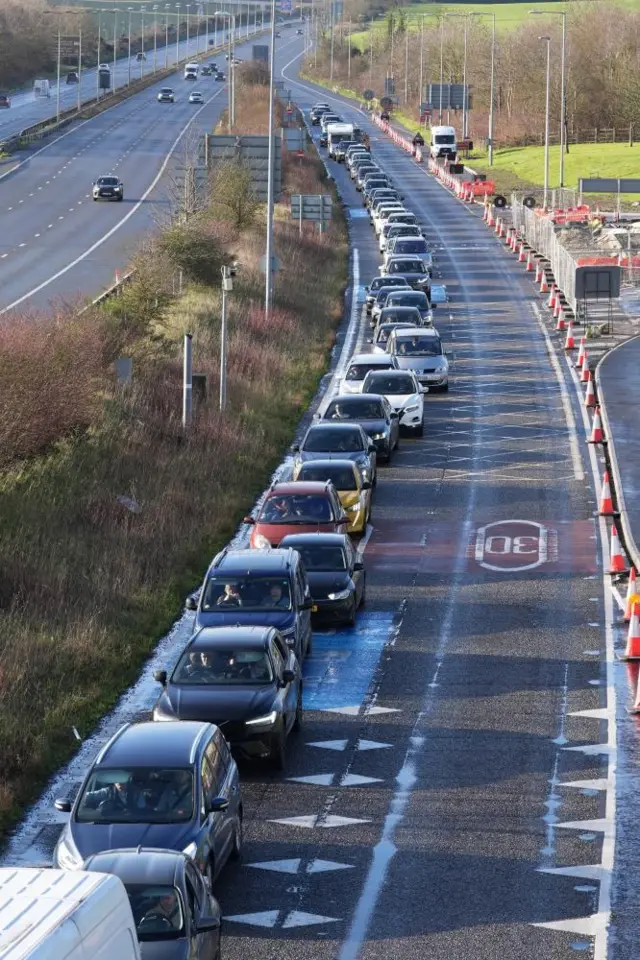 Passengers queue to enter the Eurotunnel site in Folkestone in Kent. Eurostar has asked customers not to travel today because of a problem with the overhead power supply in the Channel Tunnel and a failed Le Shuttle train. Picture date: Tuesday December 30, 2025.