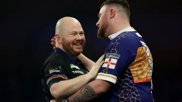Justin Hood shakes hands with Josh Rock