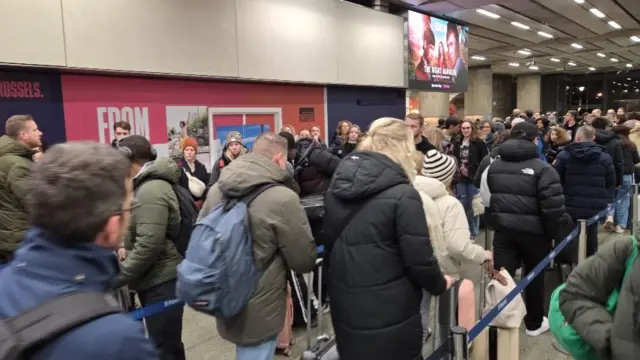 People queue between barriers at St Pancras