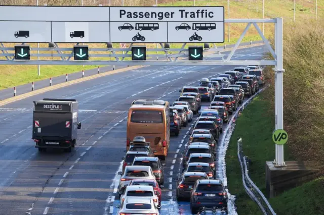 Passengers queue to enter the Eurotunnel site in Folkestone in Kent. Eurostar has asked customers not to travel today because of a problem with the overhead power supply in the Channel Tunnel and a failed Le Shuttle train. Picture date: Tuesday December 30, 2025.