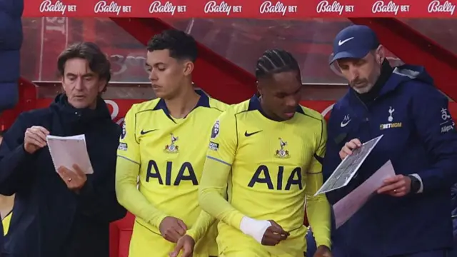 Johnson receives instructions from Frank as he prepares to come on as a sub