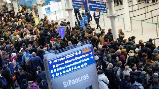 Crowds stand at St Pancras station in London