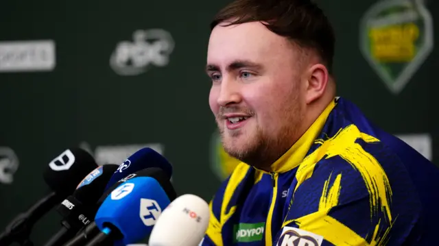Luke Littler speaks at a press conference