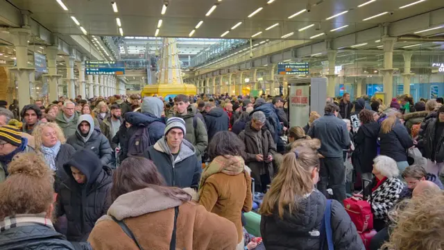 A crowd of people in St Pancras station near the Eurostar terminal