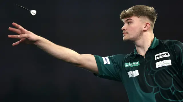 Charlie Manby throws a dart