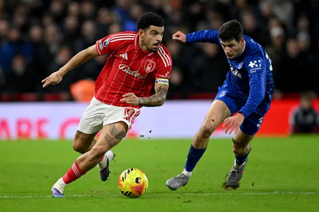 Morgan Gibbs-White is challenged by Merlin Roehl