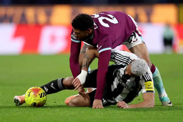 Josh Laurent of Burnley battles for possession with Joelinton of Newcastle United