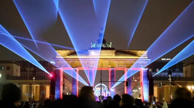 People gather in front of the Brandenburg Gate for the New Year's Eve celebrations in Berlin