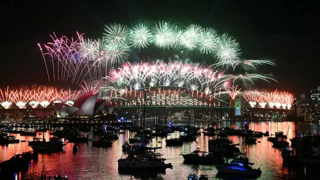 Fireworks light up the midnight sky over Sydney Harbour Bridge and Sydney Opera House during New Year's Day celebrations in Sydney on January 1, 2026.
