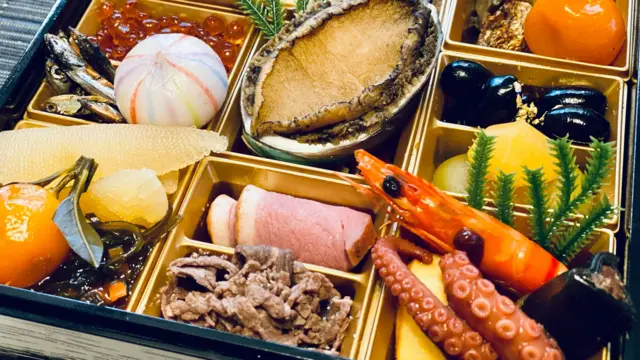 A selection of Japanese Osechi Ryori dishes including octopus, prawns, meats and fruits