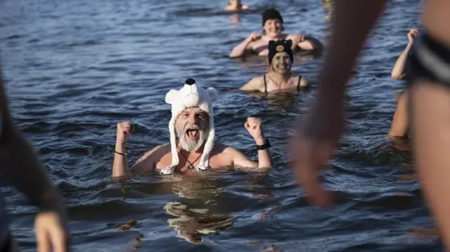 People take part in the traditional Sylvester swim at lake Moossee in Moosseedorf, Switzerland, 31 December 2025. Enthusiasts take a dip in lake Moossee in water temperatures between 1 and 2 degrees Celsius to wash away old sins and begin the New Year with a purified body and mind. New Year's Eve traditional swim in Moosseedorf, Switzerland - 31 Dec 2025