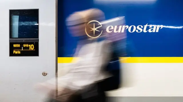 A blurred figure passes in front of Eurostar sign