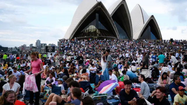 : People gather at the Sydney Opera House in anticipation of the annual New Year's Eve fireworks display on December 31