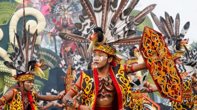 Balinese dancers perform as they take part in a cultural parade, during a New Year's eve celebration on a main road in Denpasar, Bali, Indonesia, 31 December 2025.