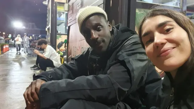 Aly and Francesca pose for a selfie in the street